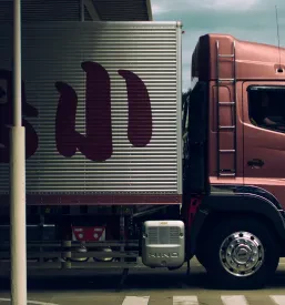 Dinamična podoba pomorskega transporta v pristanišču z ladjami in delavci, ki usklajujejo pretovor blaga kot pomorski agent Luke Koper.