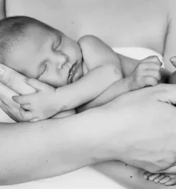 Mother holding a newborn in black and white