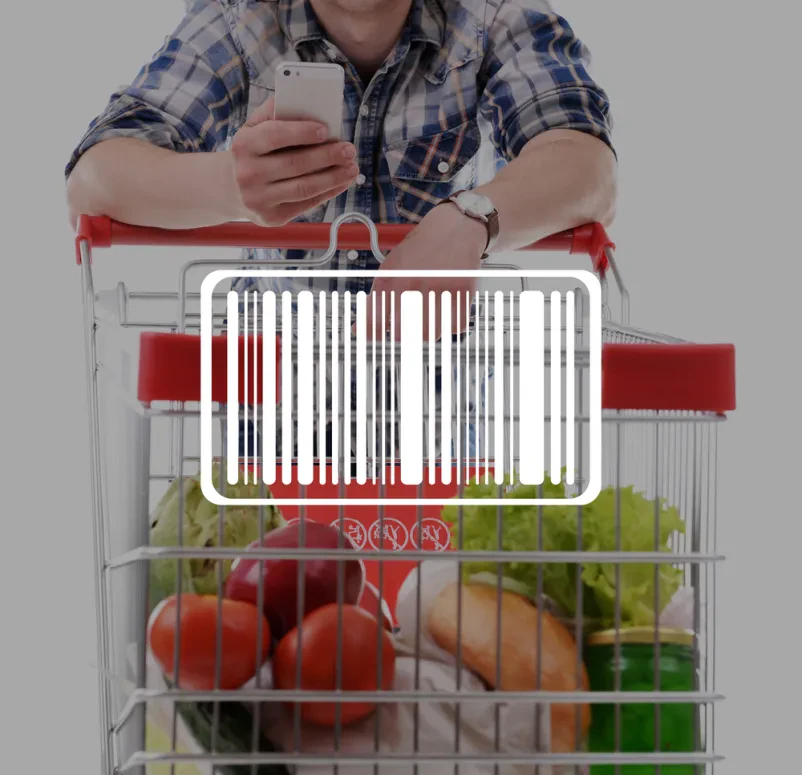 Makro posnetek črtne kode na nakupovalnem vozičku simbolizira obsežne nakupe in procese trgovine na debelo.