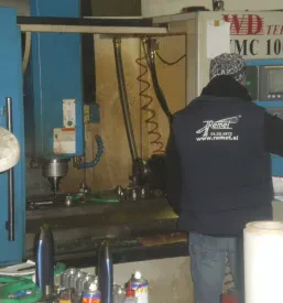 Prikaz nadzornega dela industrijske linije, kjer se spremlja in optimizira proces obdelave kovinskih izdelkov.